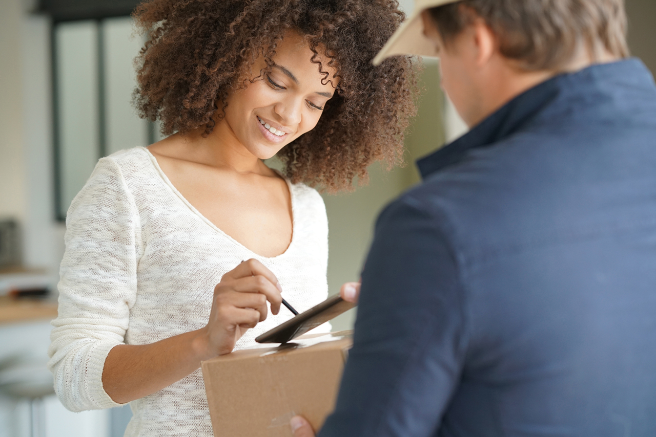 Lady signing for a package delivery